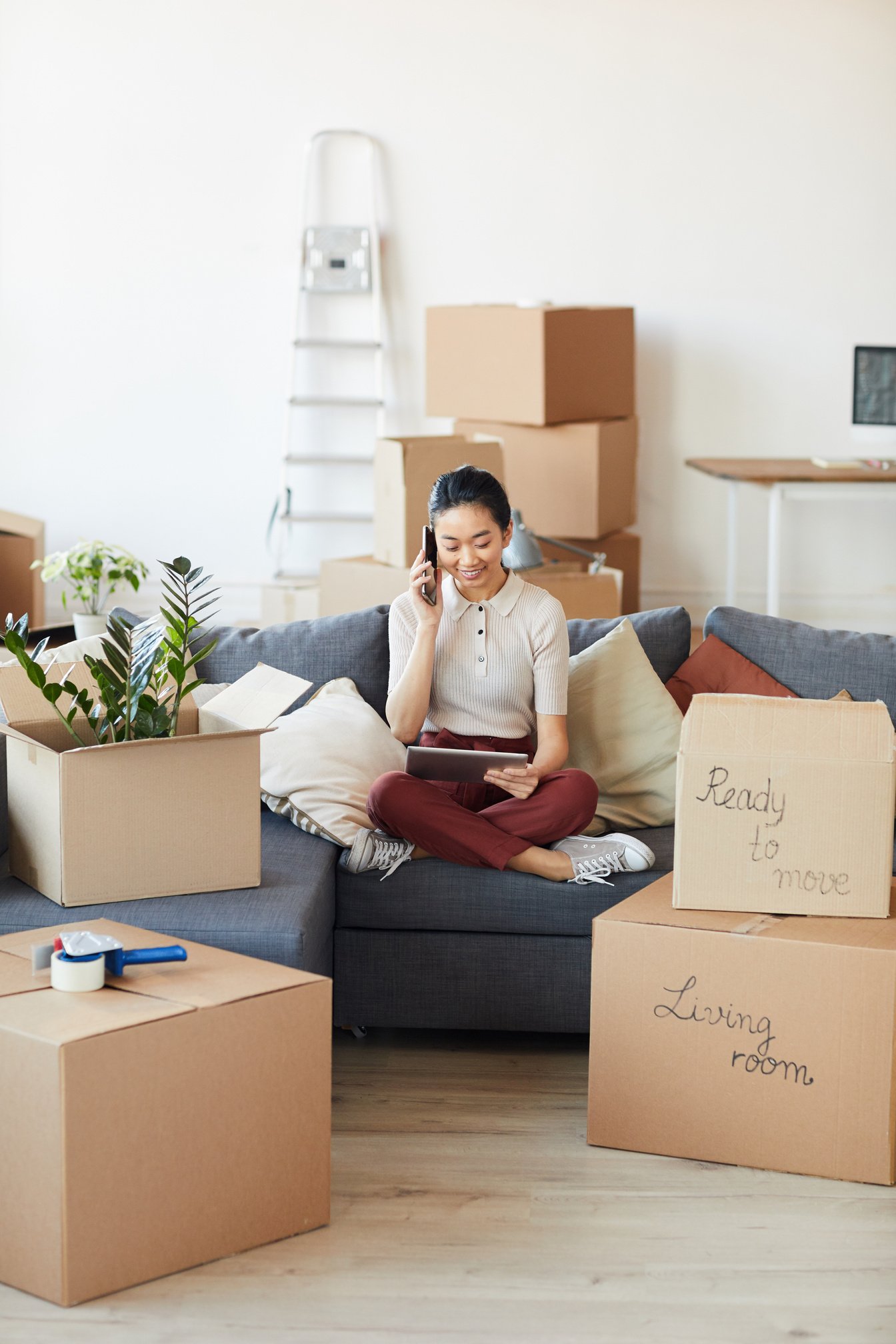 Young Asian Woman Calling Moving Services